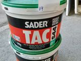 three buckets of paint sitting on the floor with a tag attached to them