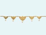 a close up of a gold bracelet with hearts and pearls
