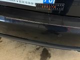 a black car with a number plate on the back of it