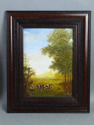 two framed paintings of cows in a pasture with trees in the background