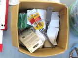 a cardboard box filled with assorted items on a table