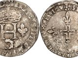 a silver coin with a crown on top of it