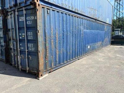 a large blue container sitting in the middle of a parking lot