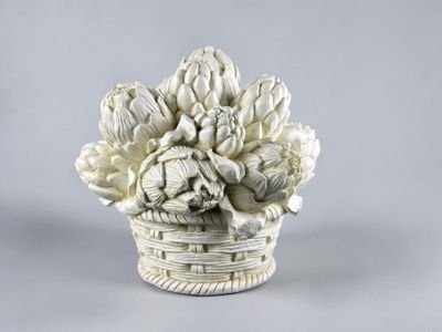 a white vase with a bunch of flowers in it