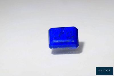 a close up of a blue plastic object on a white surface