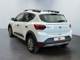 the rear end of a white car parked in a room