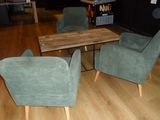 three chairs and a table in a room with wood floors
