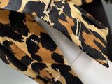 a close up of a leopard print jacket on a mannequin mannequin mannequin mannequin mannequin mannequin mannequin mann