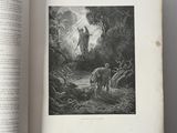 an open book with a picture of a man and a dog in a forest