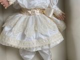 a doll that is in a box on a shelf