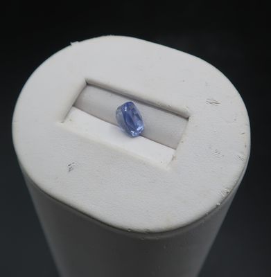 a blue sapphire in the middle of a white container