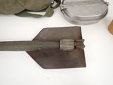 a shovel, a bag, and other items on a table