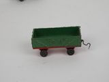 two toy trains that are sitting on a white surface