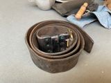 a leather belt that has a couple of dice in it