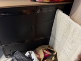 a pile of bags sitting on the floor next to a chair