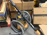 a vacuum that is sitting on the floor in front of a pile of boxes