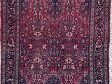 tapis persan ancien à motif floral sur fond rouge
