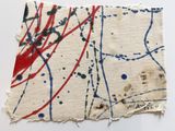 a close up of a piece of fabric with paint splatters on it