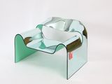 a glass table with a bowl on top of it