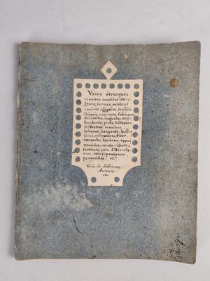 an old book with writing on it sitting on a table