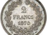 a silver coin with a laurel wreath on it