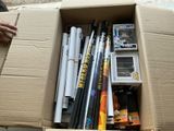 a cardboard box filled with baseball bats and other items