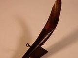 a horn shaped object on a stand on a table