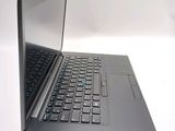 a laptop computer sitting on a table with a keyboard