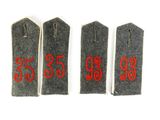 three tags with red numbers on them on a white surface