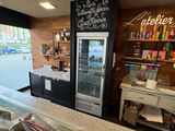 an image of a bakery with a counter and a refrigerator