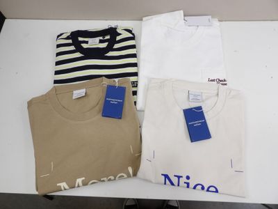 three t - shirts are sitting on a table with a price tag