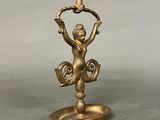 bronze figurine of a monkey holding a candle holder on a base