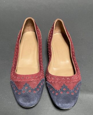 pair of women ' s shoes with red and blue sued uppers