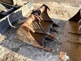 a close up of a bucket and a bulldozer on the ground