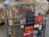a metal cart with many items in it in a warehouse