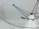 a glass table with a metal base and a glass table top
