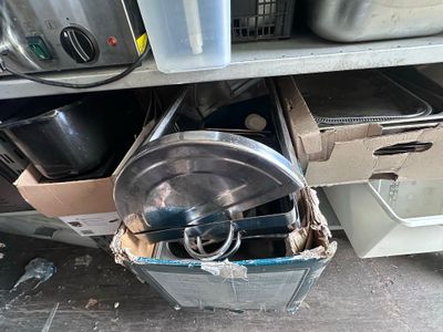many pots and pans that are in a trash can