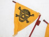 yellow pirate flag with black skull and crossbones on it