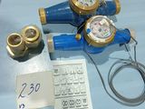 three different types of water meters on a blue table