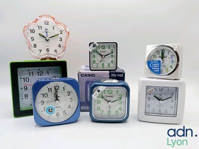 five different clocks sitting on top of each other