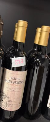 several bottles of wine are lined up in a row on a shelf