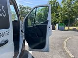 a white van with the door open in a parking lot