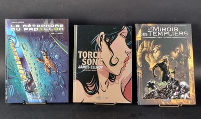 three books are lined up on a table with a black background