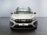 the front view of a silver car in a white room