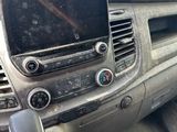 a dirty dashboard of a car with a phone in it