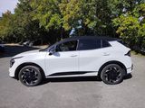a white suv parked in a parking lot with trees in the background