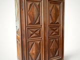 an image of a wooden armoire with a clock on top of it