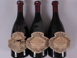 three bottles of wine with labels on them sitting next to each other