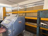 a machine that is sitting in a room with shelves