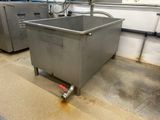 a large metal container with a handle on the floor